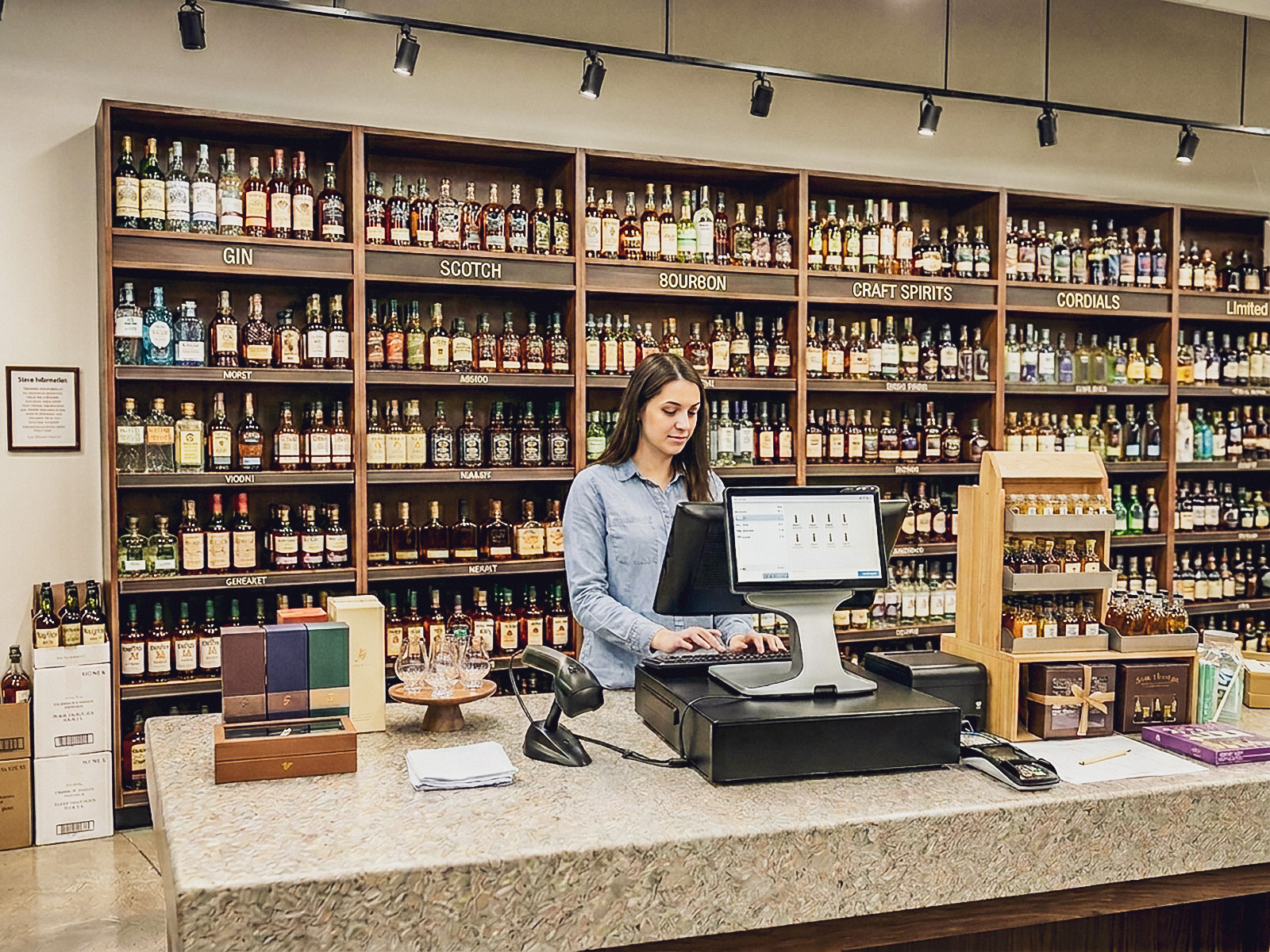 Customer paying by card at an all-in-one register at a retail checkout counter