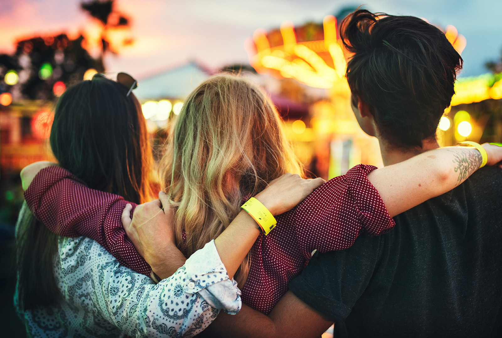 Family with wristbands and phone passes enjoying an attraction