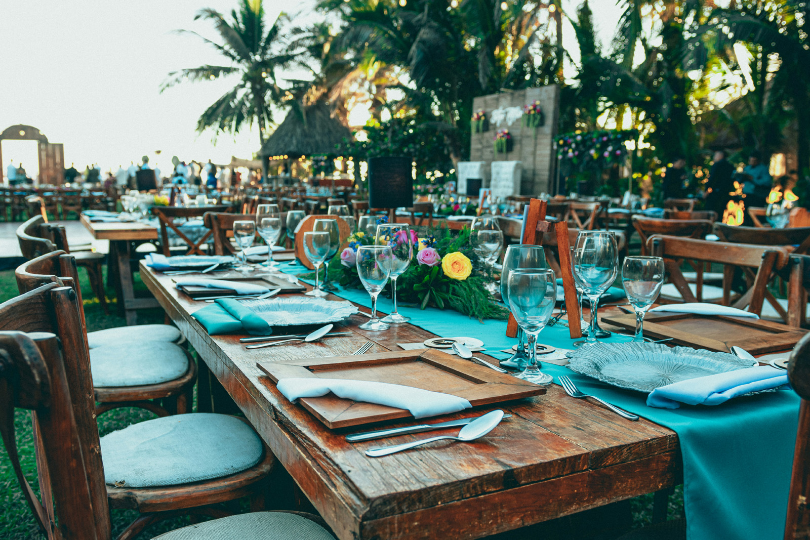 Elegant event or wedding setup with draped tables and place settings in warm, upscale light