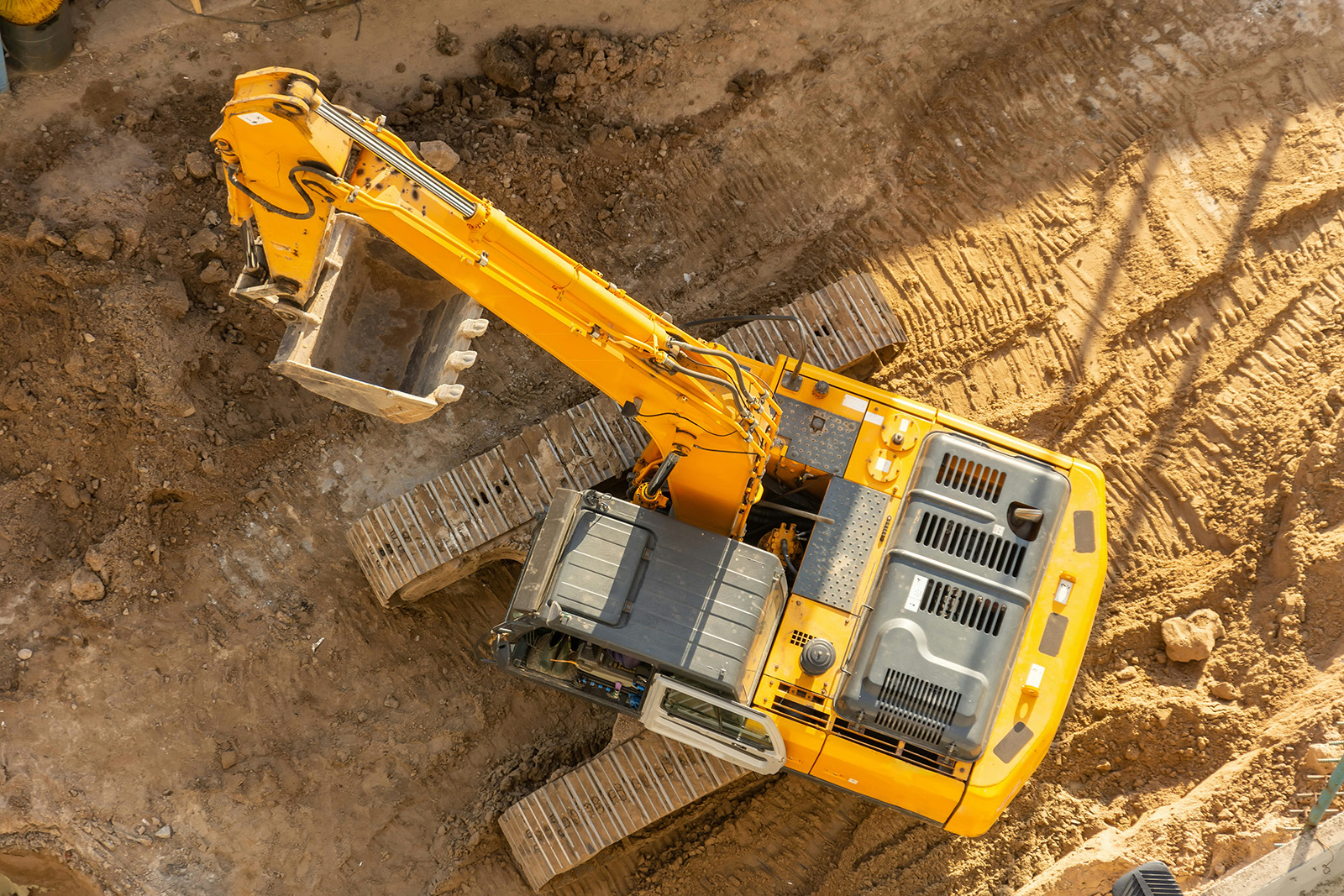 Signed equipment rental contract on a truck tailgate with heavy equipment behind