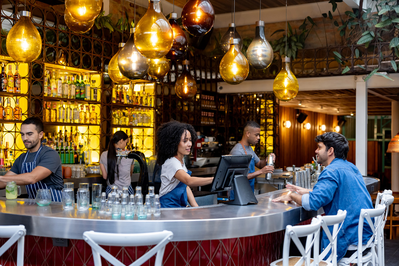 All-in-one terminal at a host stand or service station, dining room softly blurred behind