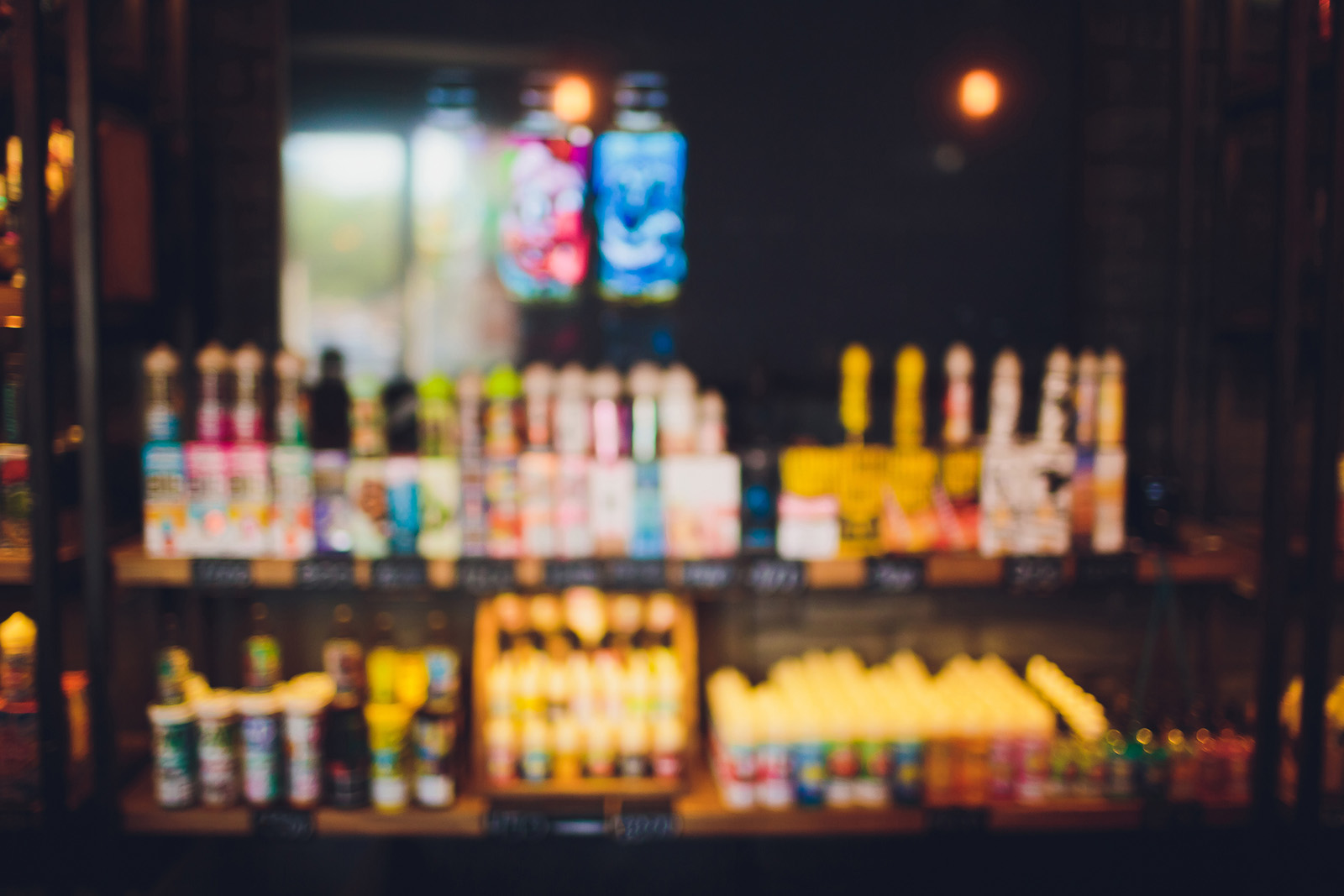 A modern smoke or vape shop interior with a well-merchandised wall behind the counter; clean, professional…
